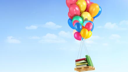 Photo of books being carried through sky by baloons