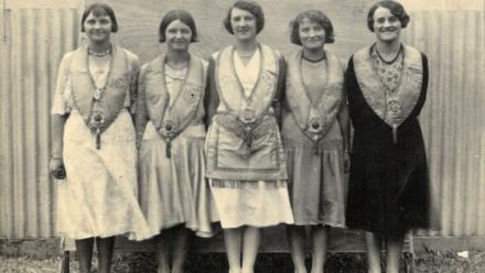 Black and white photo of five women wearing Manchester Unity Independent Order of Oddfellows from the 1920s