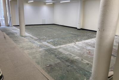 Photograph of the Art & Music Library - September 2024 - showing empty internal space where compactus used to be, and dusty floors